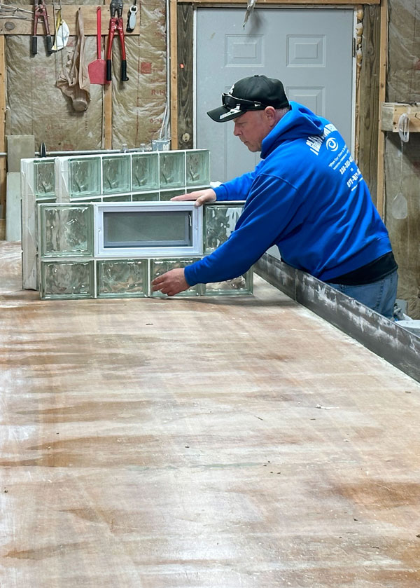 Glass Block Basement Windows - Photo of Owner David Villoni in the shop building building a glass block basement window.