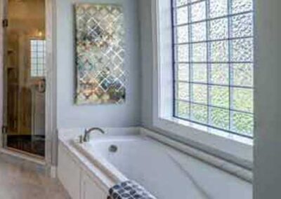 Glass Block Bathroom Windows - Photo of a large glass block window above a tub in an upscale bathroom.