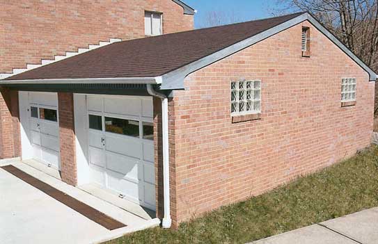 Glass Block Garage Windows - Photo of two glass block window on the side of a brick garage wall.